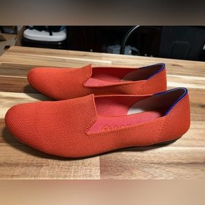 Rothy’s loafers, size 9. Tangerine color with pink stripe on heel.